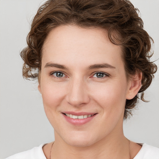 Joyful white young-adult female with medium  brown hair and green eyes