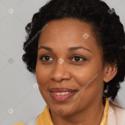 Joyful black adult female with short  brown hair and brown eyes