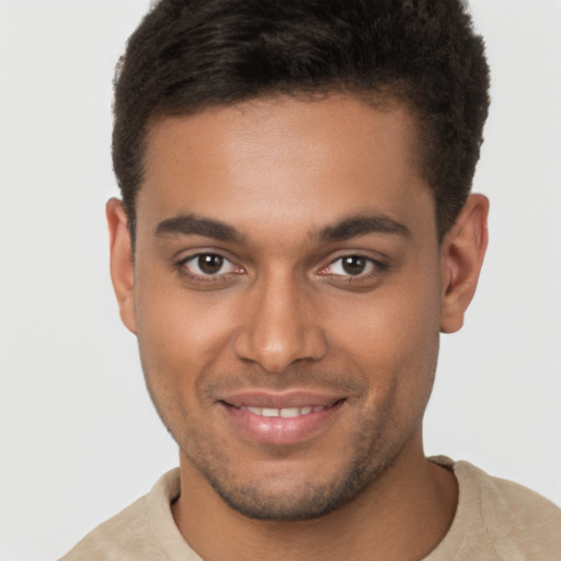 Joyful black young-adult male with short  brown hair and brown eyes