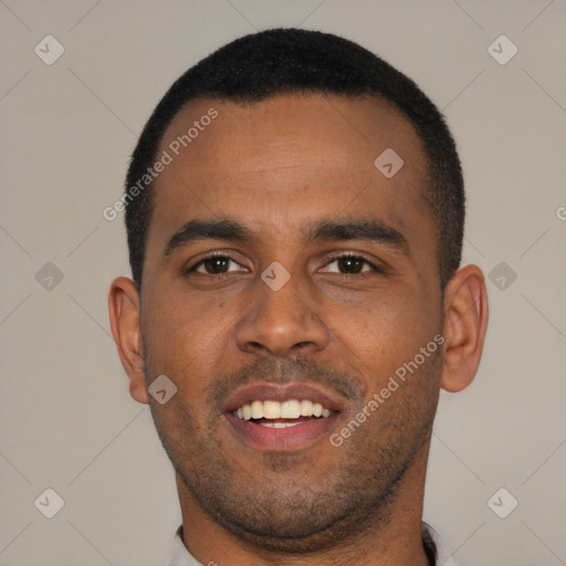 Joyful black young-adult male with short  brown hair and brown eyes