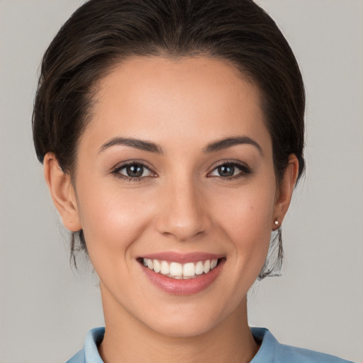 Joyful white young-adult female with medium  brown hair and brown eyes