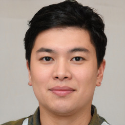 Joyful asian young-adult male with short  black hair and brown eyes