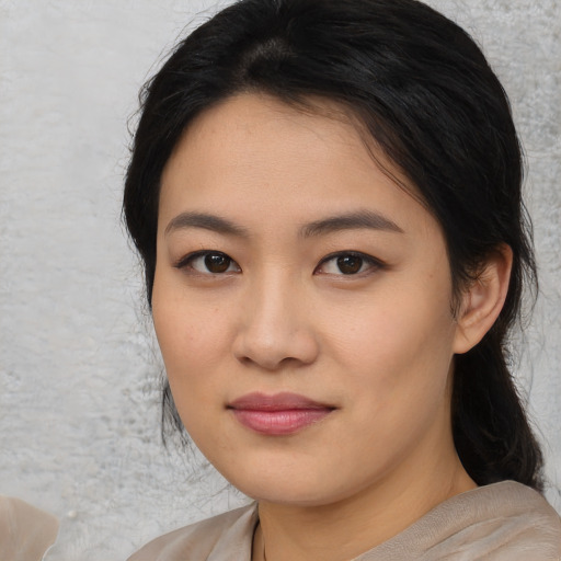 Joyful asian young-adult female with medium  black hair and brown eyes