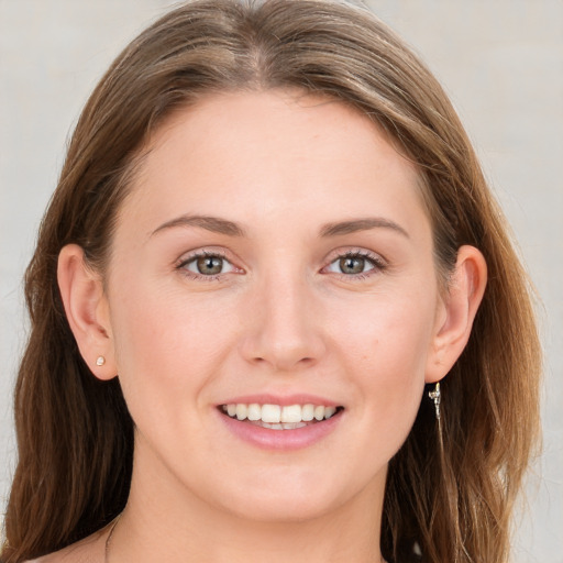 Joyful white young-adult female with long  brown hair and grey eyes