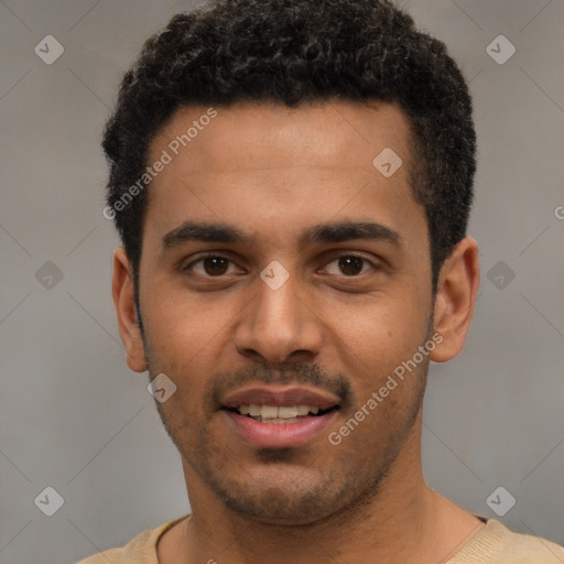 Joyful black young-adult male with short  brown hair and brown eyes