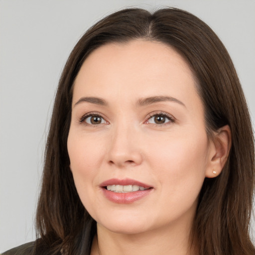 Joyful white young-adult female with long  brown hair and brown eyes