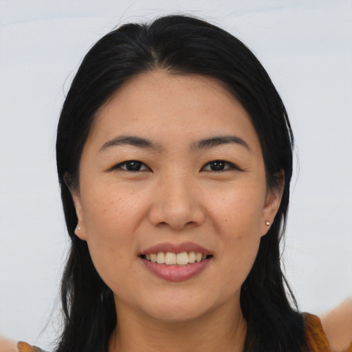 Joyful asian young-adult female with long  black hair and brown eyes