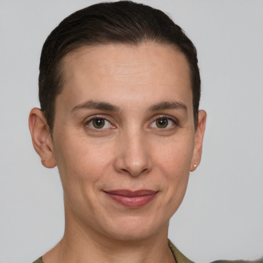 Joyful white young-adult female with short  brown hair and grey eyes