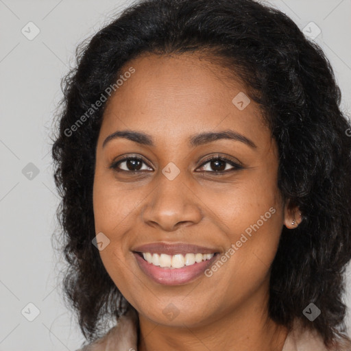 Joyful black young-adult female with long  brown hair and brown eyes