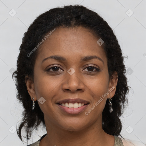 Joyful black young-adult female with long  brown hair and brown eyes