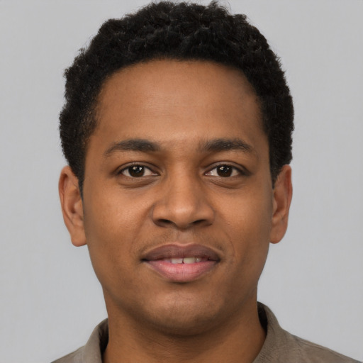 Joyful latino young-adult male with short  brown hair and brown eyes