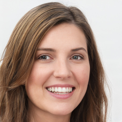 Joyful white young-adult female with long  brown hair and green eyes