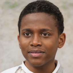 Joyful black young-adult male with short  brown hair and brown eyes