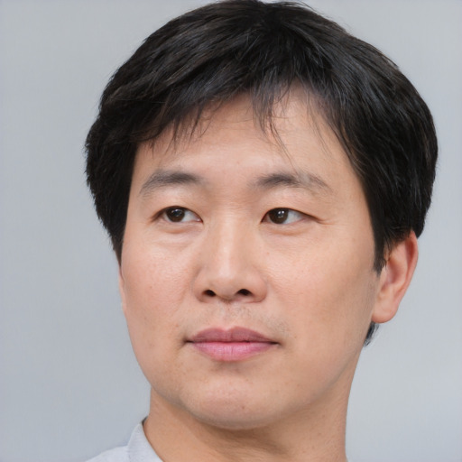 Neutral asian adult male with short  brown hair and brown eyes