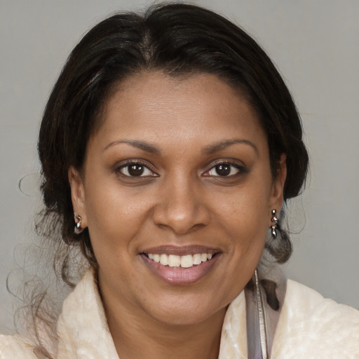 Joyful black young-adult female with medium  brown hair and brown eyes