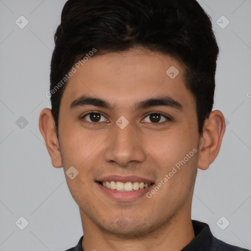 Joyful latino young-adult male with short  brown hair and brown eyes