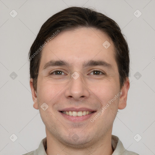 Joyful white young-adult male with short  brown hair and grey eyes