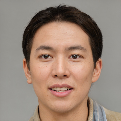 Joyful asian young-adult male with short  brown hair and brown eyes