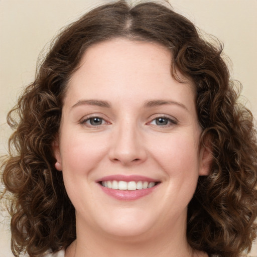 Joyful white young-adult female with long  brown hair and green eyes