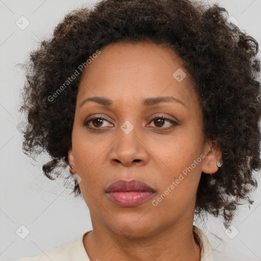 Joyful black adult female with medium  brown hair and brown eyes