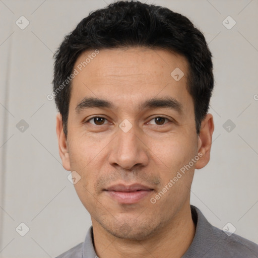 Joyful white adult male with short  black hair and brown eyes