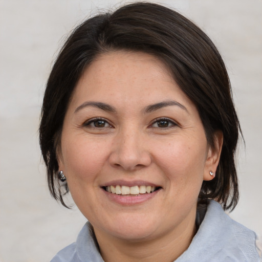 Joyful white adult female with medium  brown hair and brown eyes