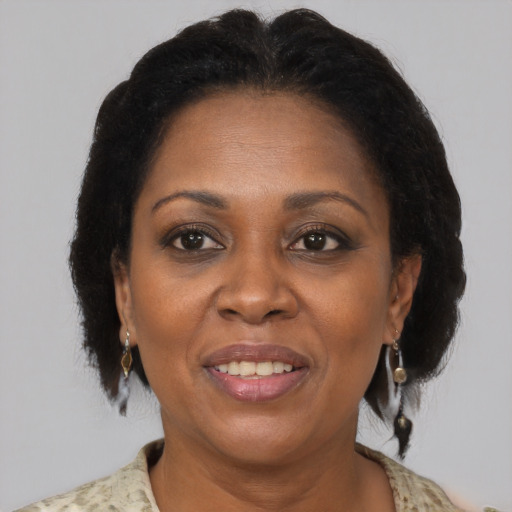 Joyful black adult female with medium  brown hair and brown eyes
