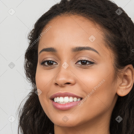 Joyful latino young-adult female with long  brown hair and brown eyes