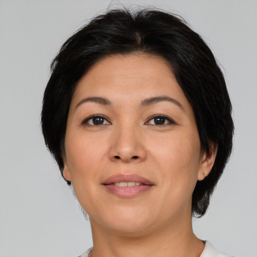Joyful asian adult female with medium  brown hair and brown eyes