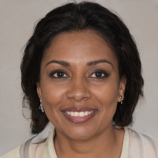 Joyful black young-adult female with medium  brown hair and brown eyes