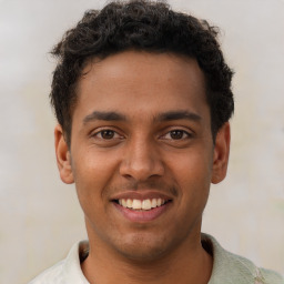 Joyful latino young-adult male with short  brown hair and brown eyes