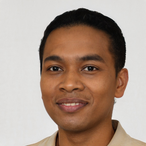 Joyful black young-adult male with short  black hair and brown eyes