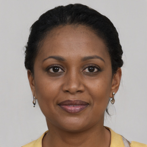 Joyful black young-adult female with short  brown hair and brown eyes