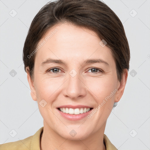 Joyful white young-adult female with short  brown hair and grey eyes