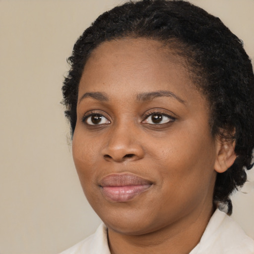 Joyful black young-adult female with medium  brown hair and brown eyes