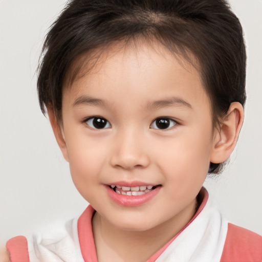 Joyful white child female with short  brown hair and brown eyes