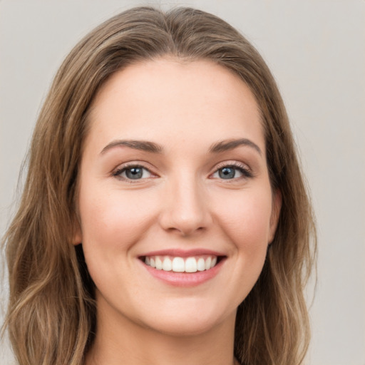 Joyful white young-adult female with long  brown hair and green eyes