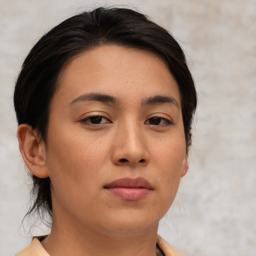 Joyful asian young-adult female with medium  brown hair and brown eyes