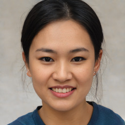 Joyful asian young-adult female with medium  black hair and brown eyes