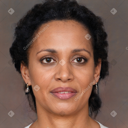 Joyful black adult female with medium  brown hair and brown eyes