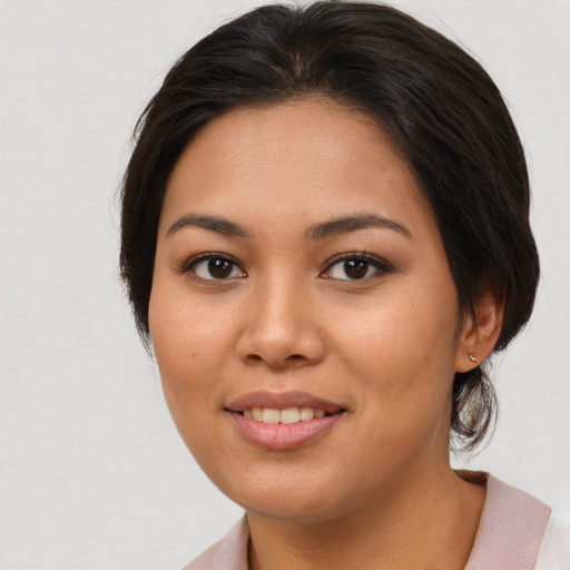 Joyful asian young-adult female with medium  brown hair and brown eyes