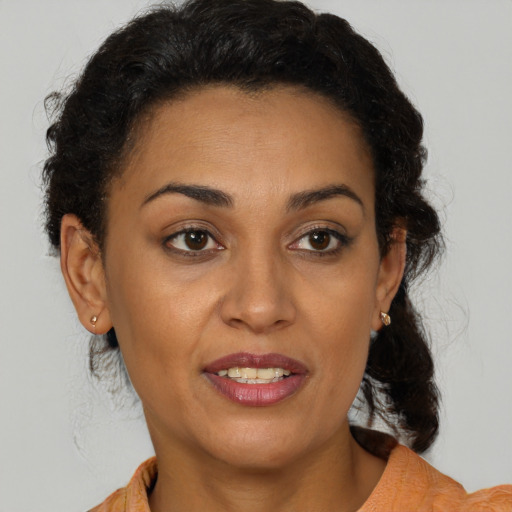 Joyful latino adult female with short  brown hair and brown eyes