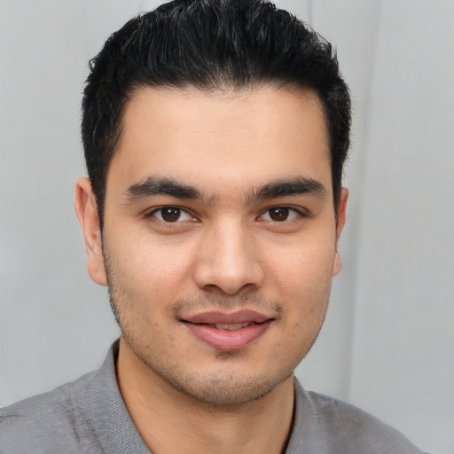 Joyful latino young-adult male with short  brown hair and brown eyes