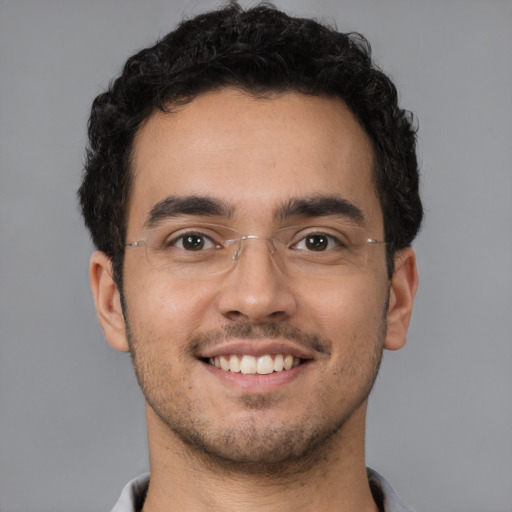 Joyful white young-adult male with short  black hair and brown eyes