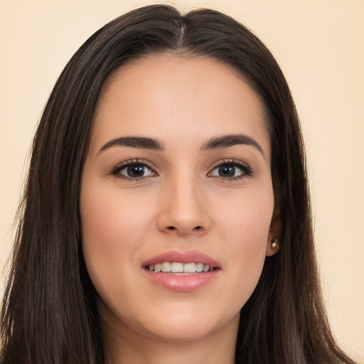 Joyful white young-adult female with long  brown hair and brown eyes