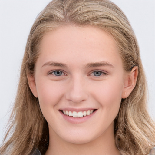 Joyful white young-adult female with long  brown hair and blue eyes