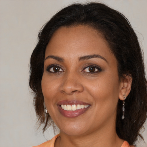 Joyful black young-adult female with medium  brown hair and brown eyes