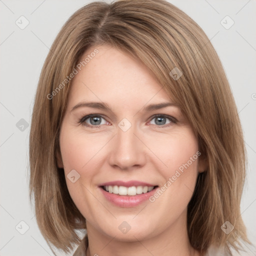 Joyful white young-adult female with medium  brown hair and green eyes