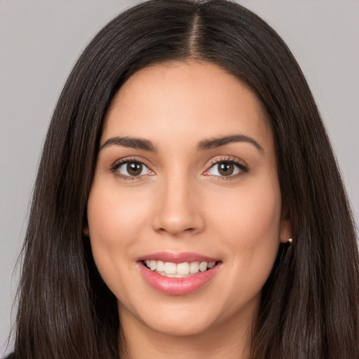 Joyful white young-adult female with long  brown hair and brown eyes