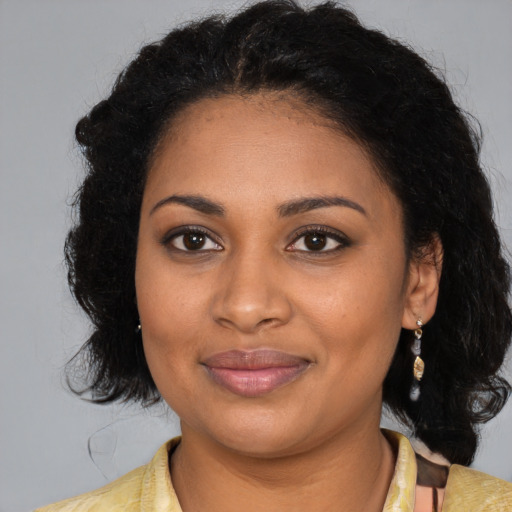Joyful black young-adult female with medium  brown hair and brown eyes